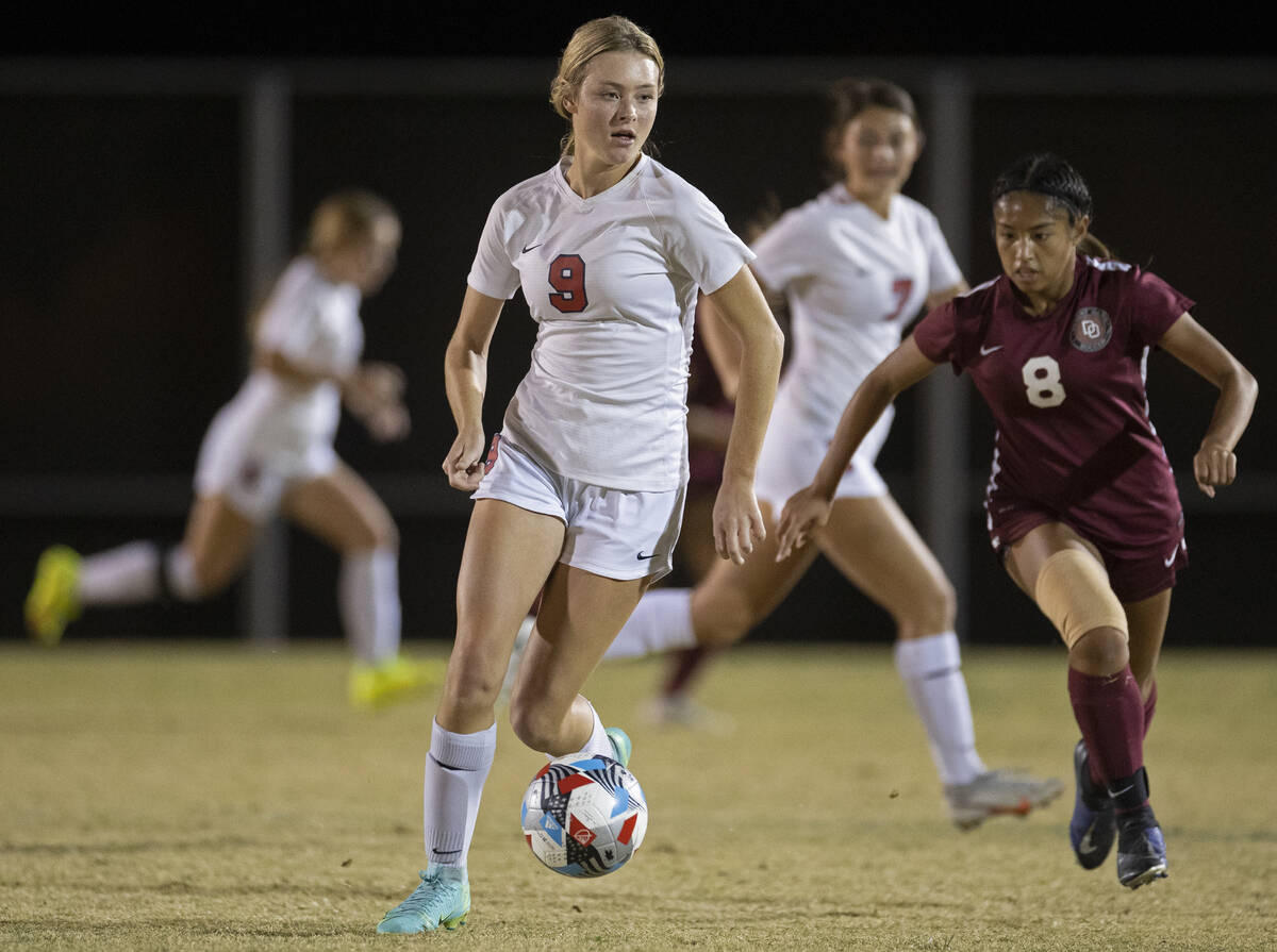 Coronado's Molly Russell (9) pushes the ball up field past Desert Oasis' Jessica Leon (8) in th ...
