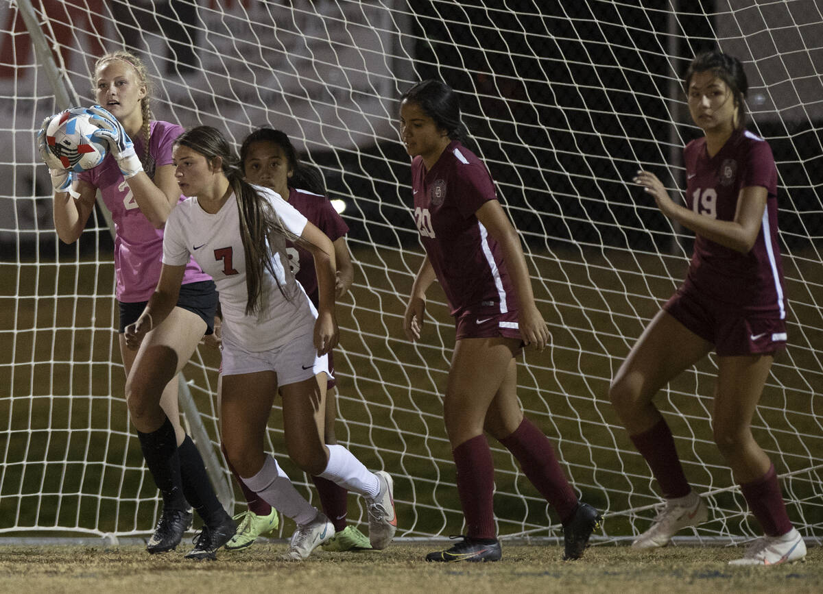 Desert Oasis' Bryanna Perry (2) makes a save against Coronado's Alexis Pashales (7) in the firs ...
