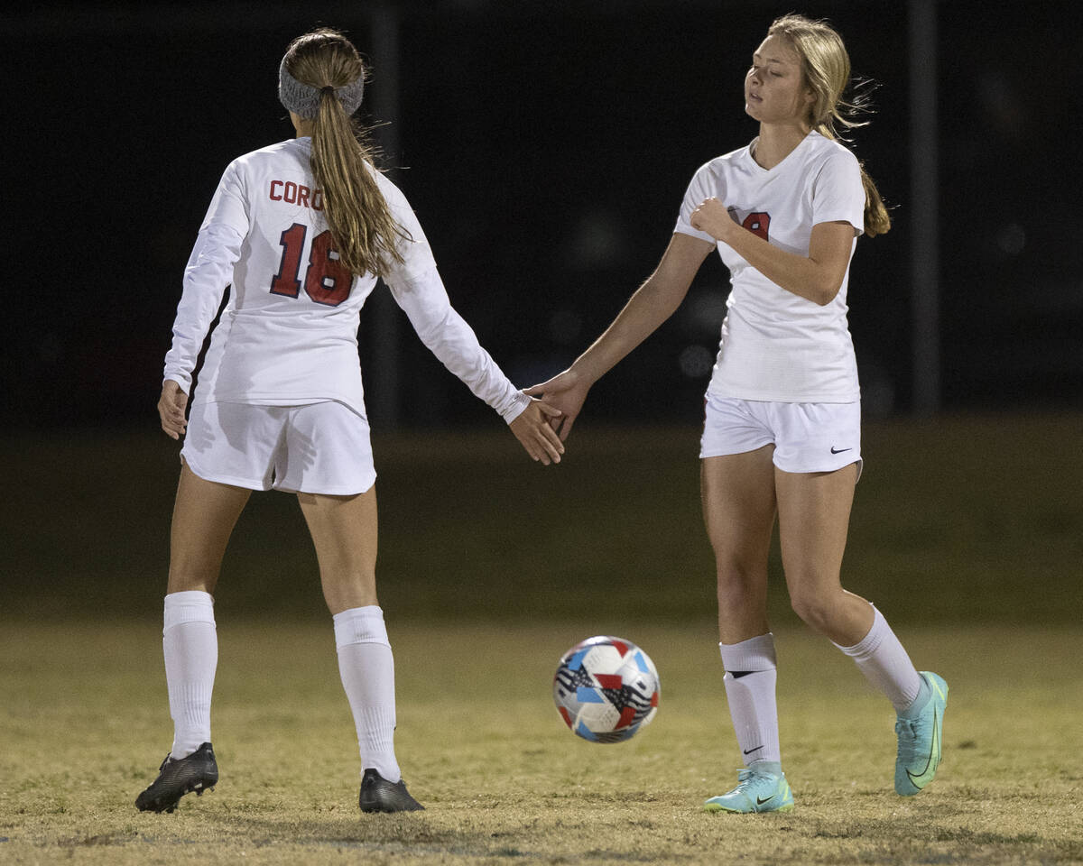 Coronado's Molly Russell (9) celebrates a extremity   with Coronado's Kylie Shin (16) successful  the archetypal  hal ...