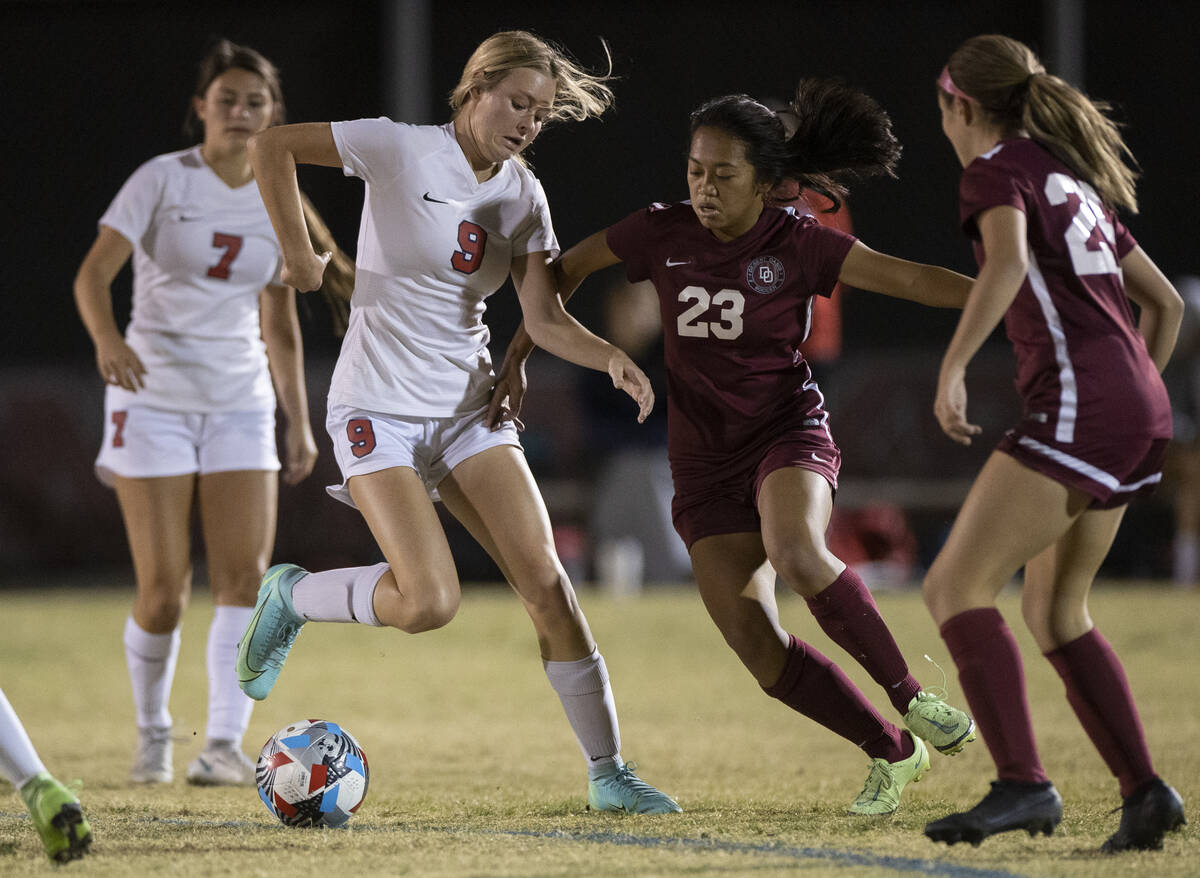 Coronado's Molly Russell (9) fights for possession with Desert Oasis' Victoria Poon (23) successful  the ...