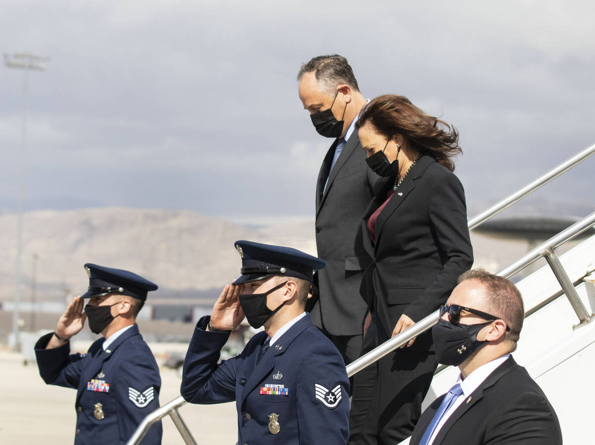 Vice President Kamala Harris and her husband, Douglas Emhoff, deplane Air Force Two upon arrivi ...