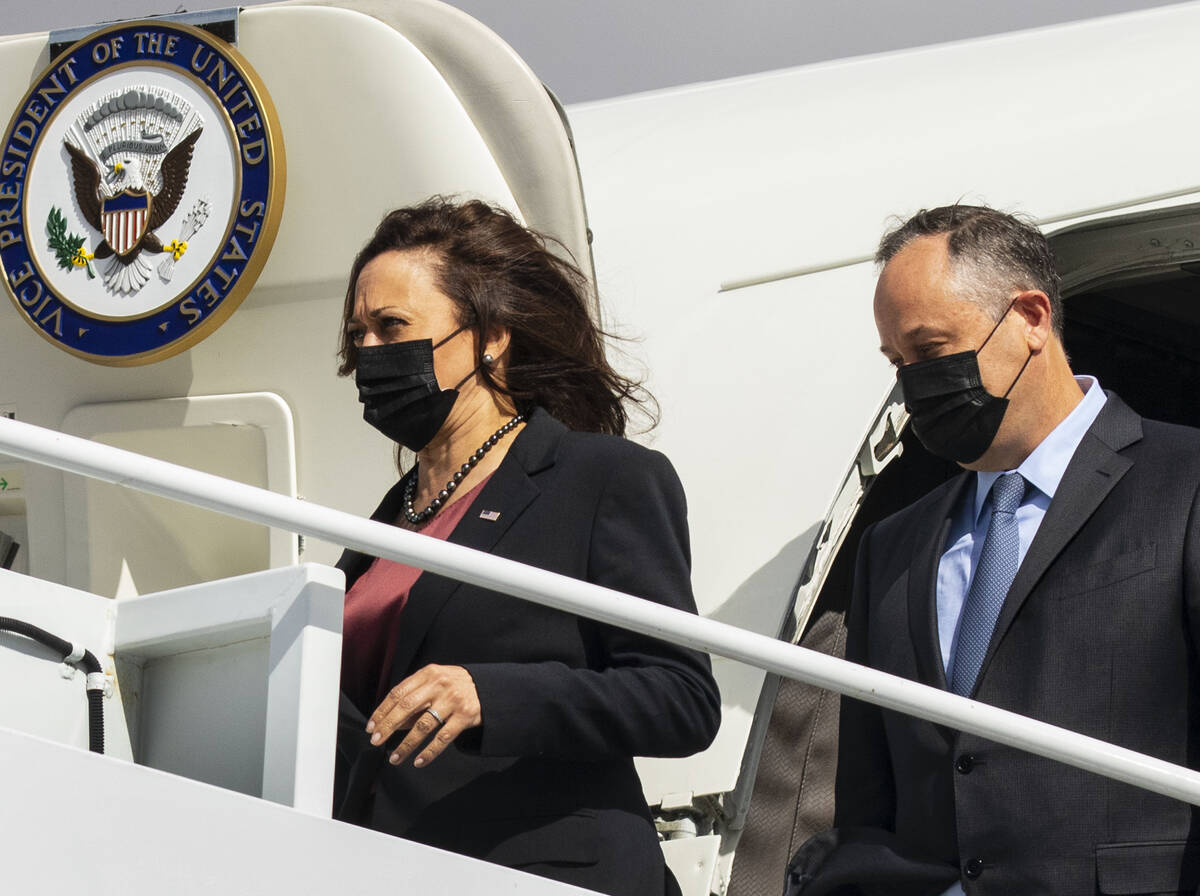 Vice President Kamala Harris and her husband, Douglas Emhoff, deplane Air Force Two upon arrivi ...