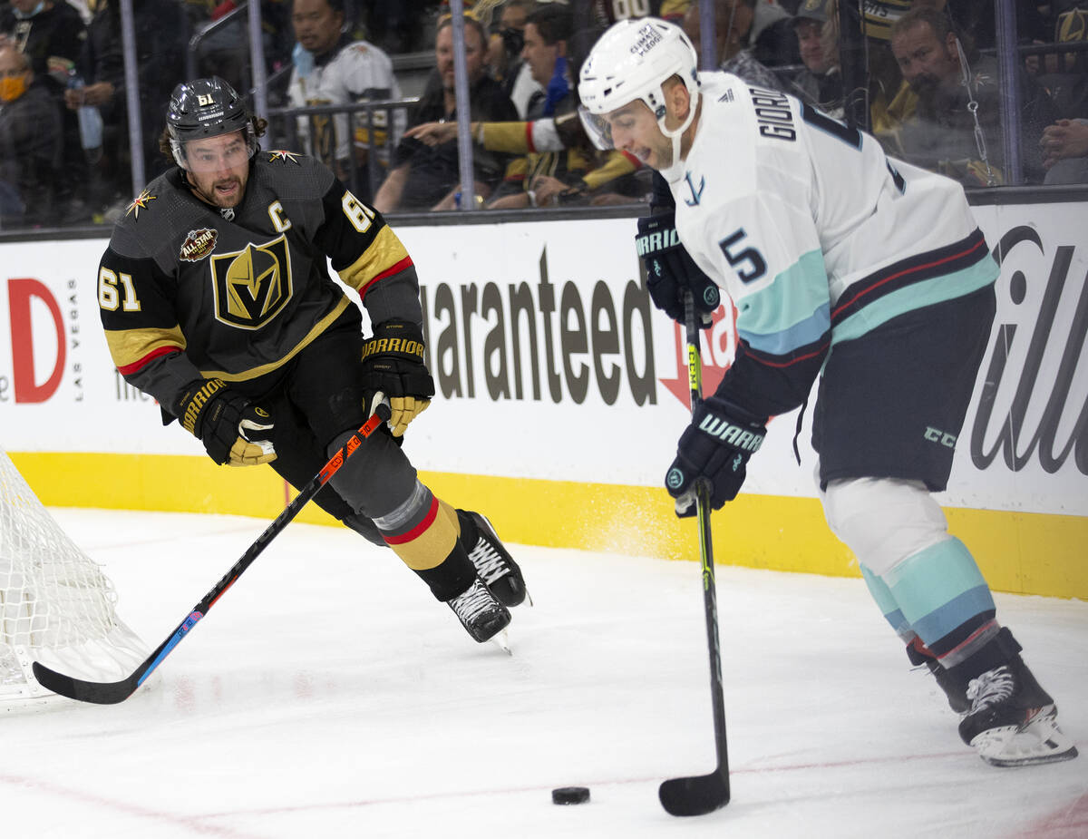 Golden Knights right wing Mark Stone (61) eyes the puck while Kraken defenseman Mark Giordano ( ...