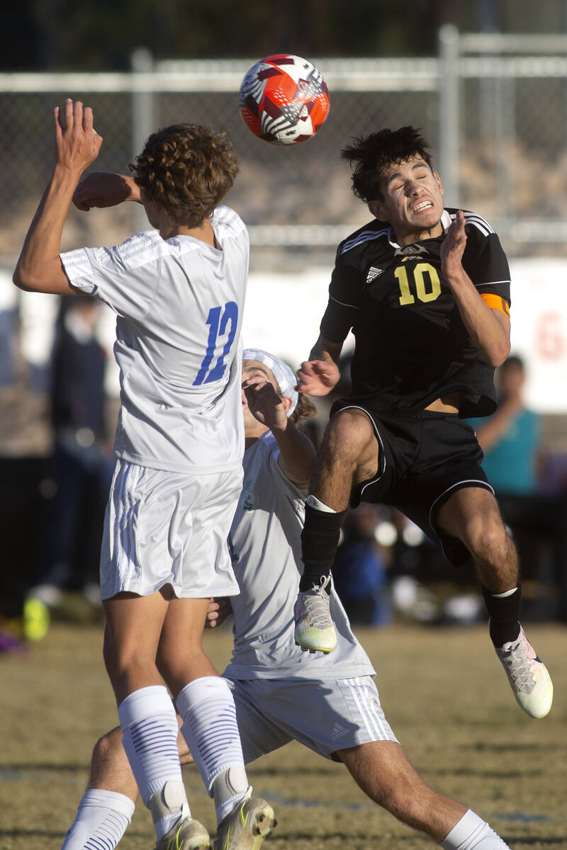 Green Valley's Kevin Kucik (12) and Sunrise Mountain's Kristan Botello (10) jump for a header d ...