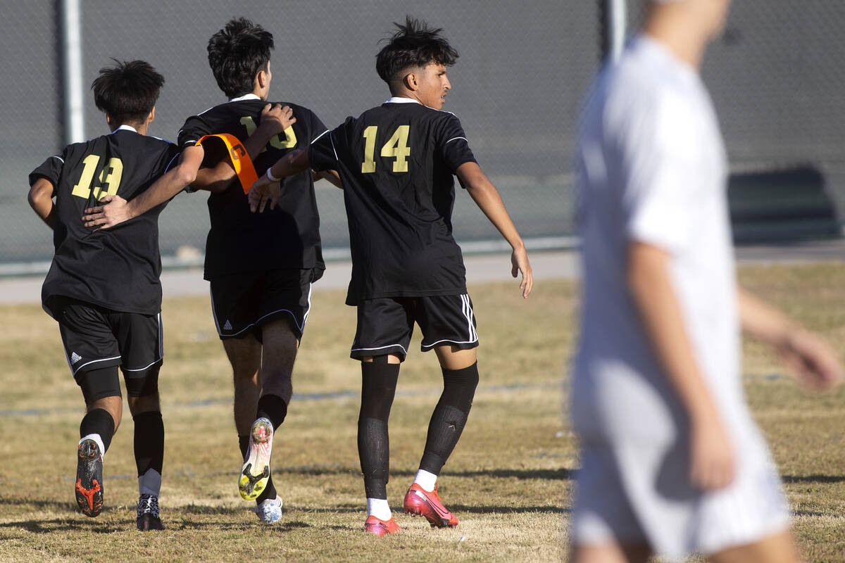 Sunrise Mountain's Caleb Castano (19) and Kevin Menjivar Gonzalez (14) congratulate Kristan Bot ...