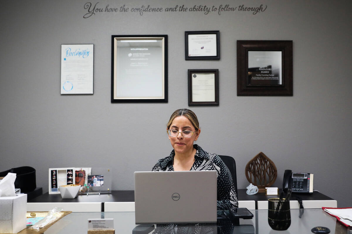 Norma Intriago, executive director of Dress For Success of Southern Nevada, works at her desk a ...