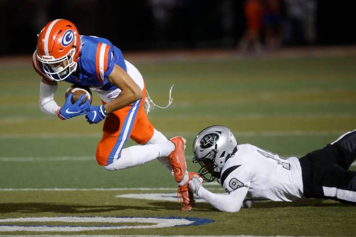 Bishop Gorman High School's Audric Harris (17) carries a ball as Palo Verde High School's Dupar ...