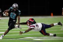 Silverado High School's Caden Harris (22) carries a ball against Coronado High School's Ryan Ha ...