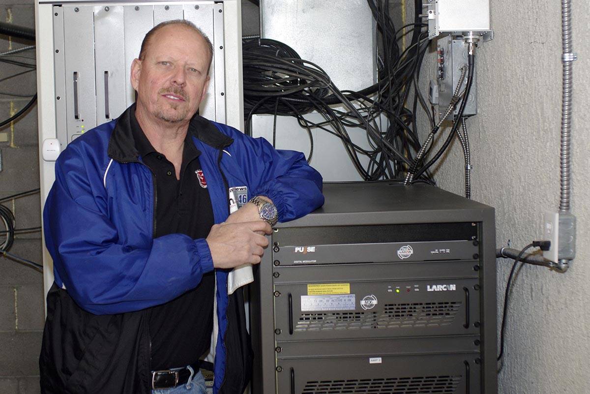 KPVM Station owner Vern Van Winkle next to digital unit. (Horace Langford Jr.)