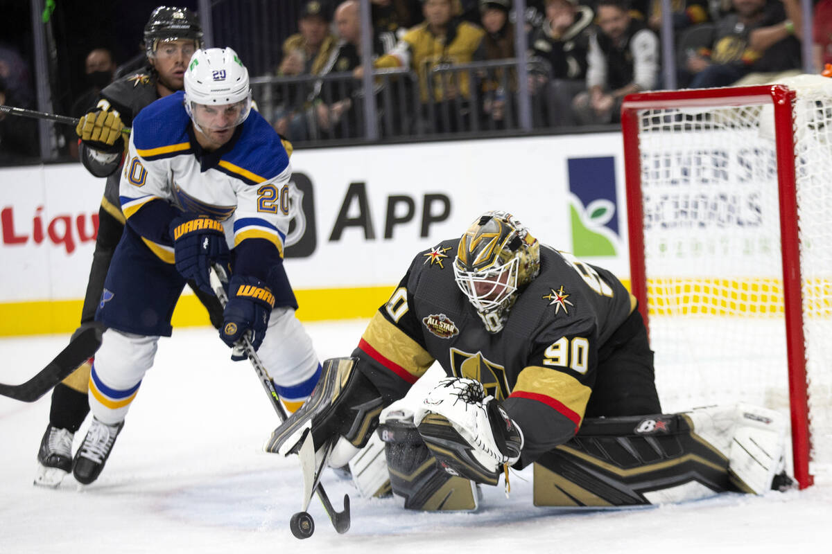 Golden Knights goaltender Robin Lehner (90) deflects a shot on goal while Blues left wing Brand ...