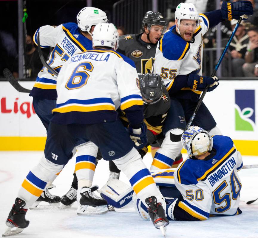 Golden Knights center Jonathan Marchessault (81) fights for the puck as Blues goaltender Jordan ...