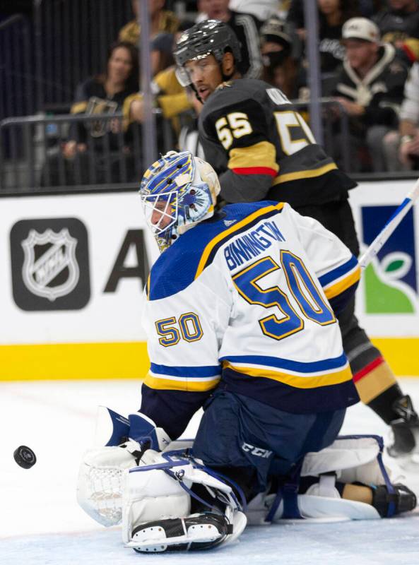 Golden Knights right wing Keegan Kolesar (55) watches behind as Blues goaltender Jordan Binning ...