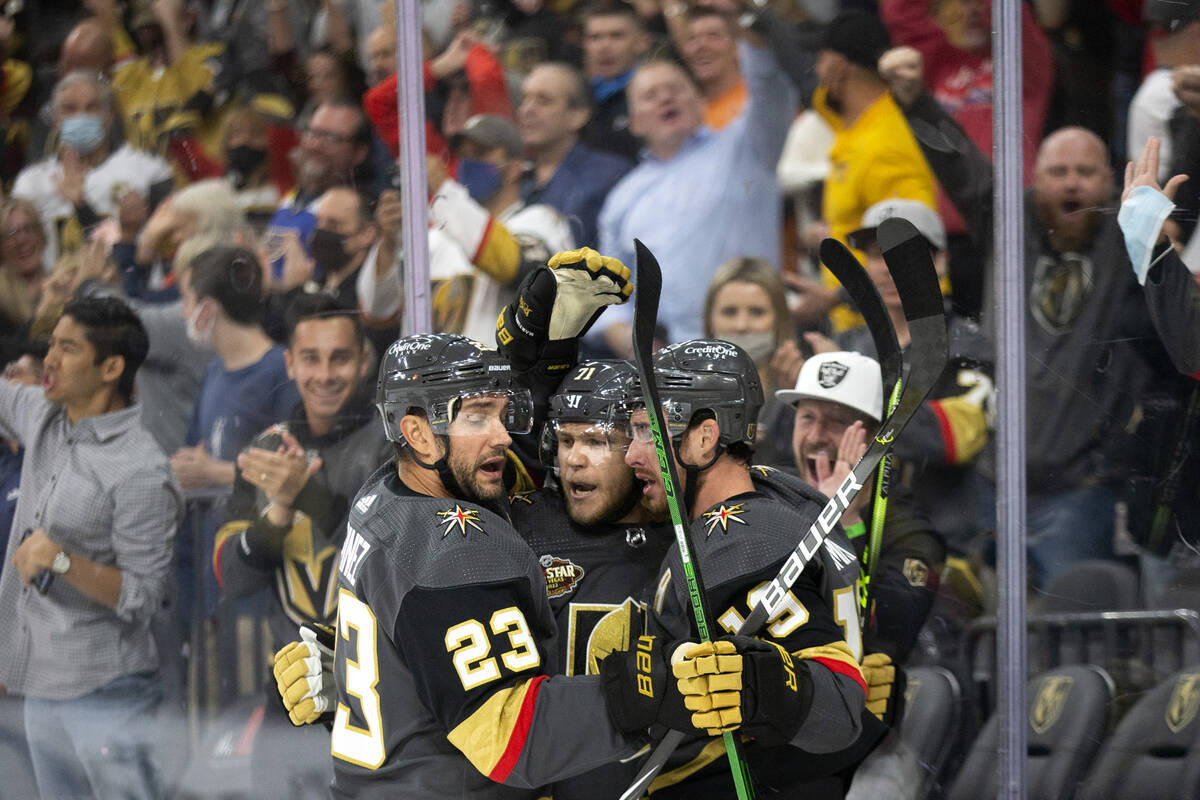 Golden Knights center William Karlsson (71) is congratulated by defenseman Alec Martinez (23) a ...