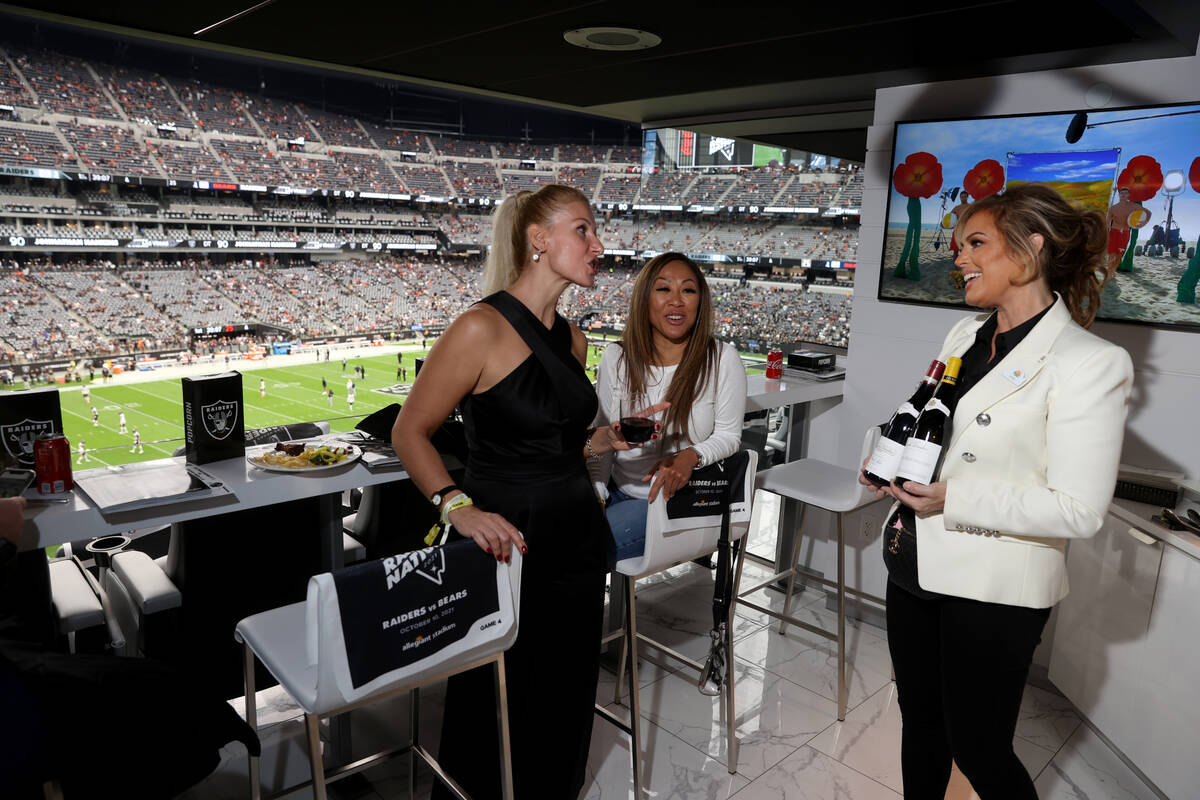 Sandra Taylor, head sommelier at Allegiant Stadium in Las Vegas, right, shows some of her wine ...