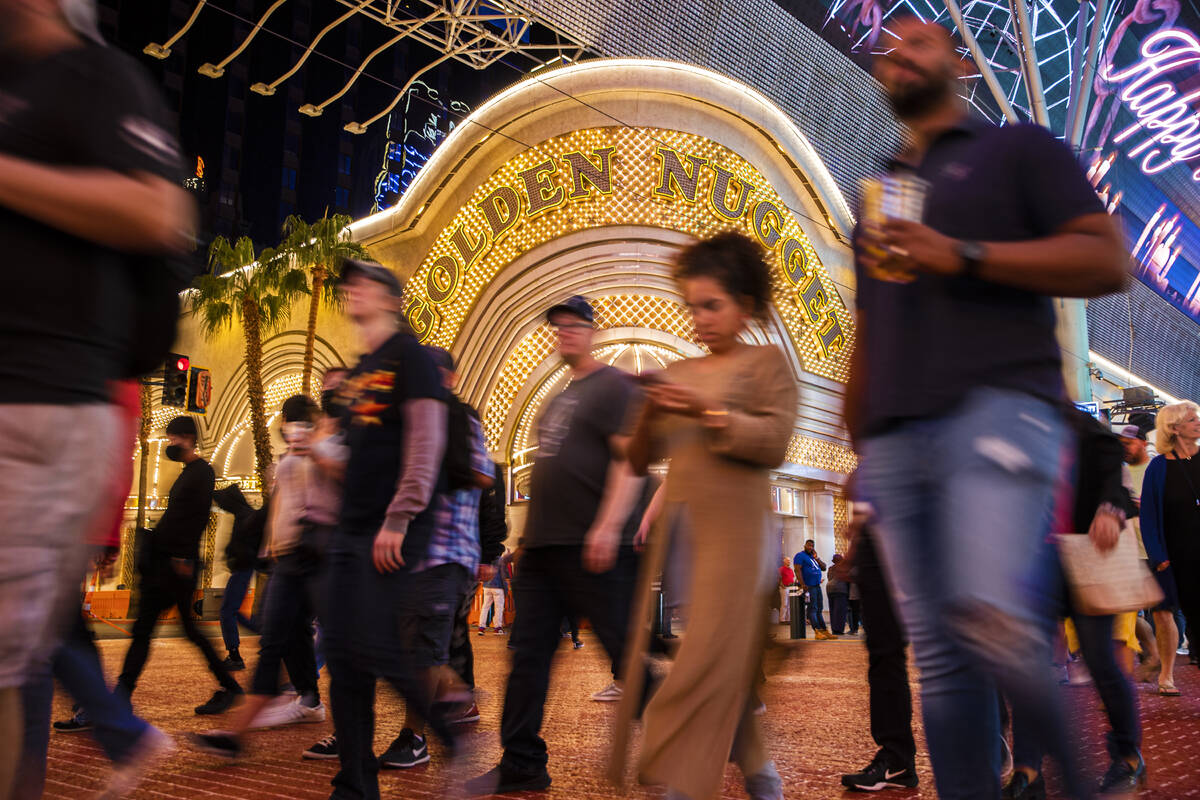 People walk past The Golden Nugget on Fremont Street on Wednesday, Oct. 20, 2021, in Las Vegas. ...