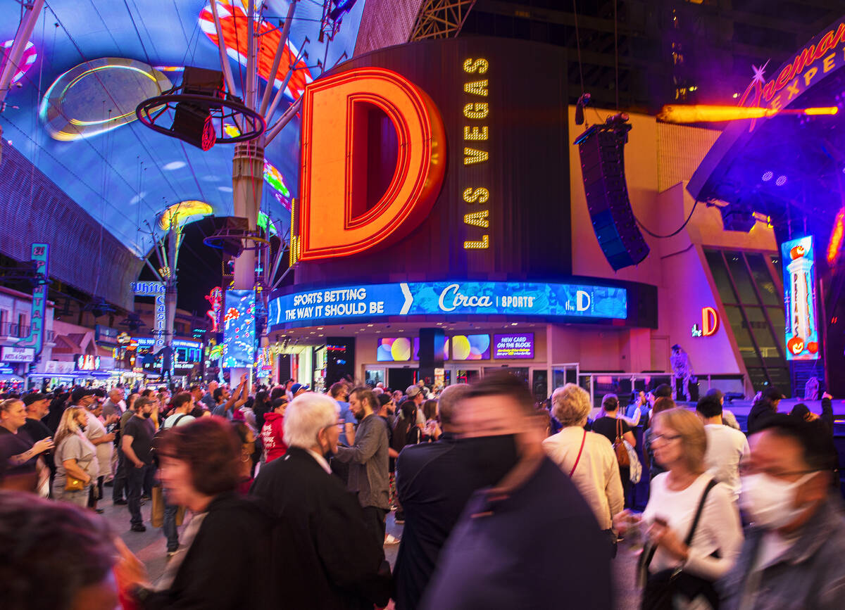 People walk past D Las Vegas on Fremont Street on Wednesday, Oct. 20, 2021, in Las Vegas. (Benj ...