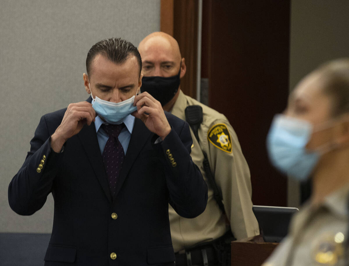 Michael Rusk led into the courtroom during his murder trial at the