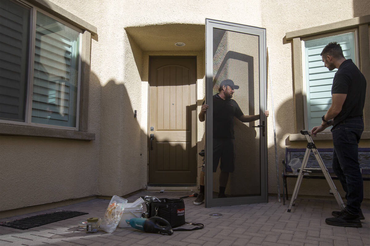 Technician Jed Roehm installs a MeshTec door at a client's home in Sun City Summerlin on Saturd ...