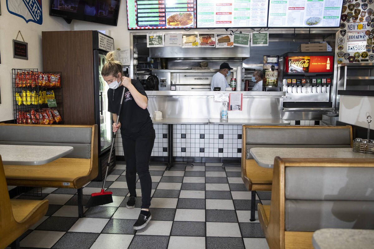 Cashier Bryte Kiser sweeps the floor at Broadway Pizza in Las Vegas, Thursday, Oct. 21, 2021. ( ...