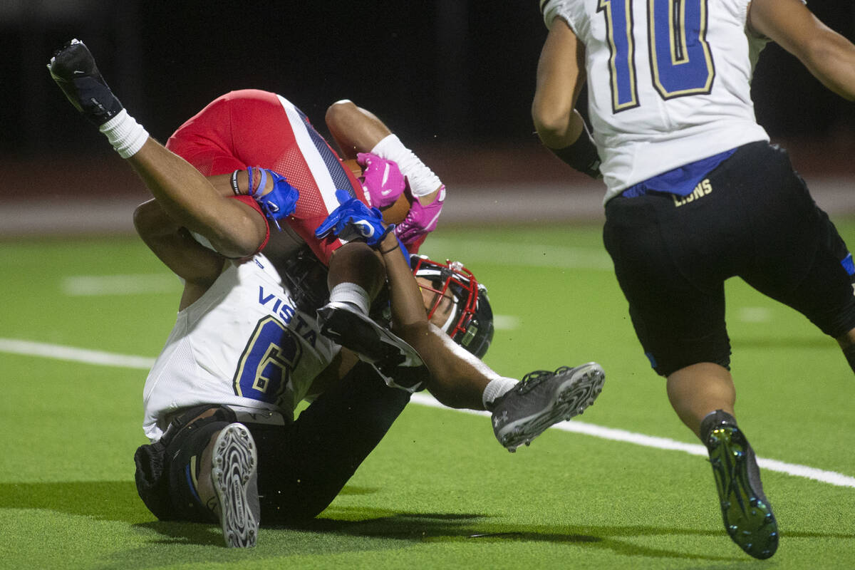 Coronado's Jaylen Garrison (10) is tackled by Sierra Vista's Akela Kahaleanu (6) during a high ...