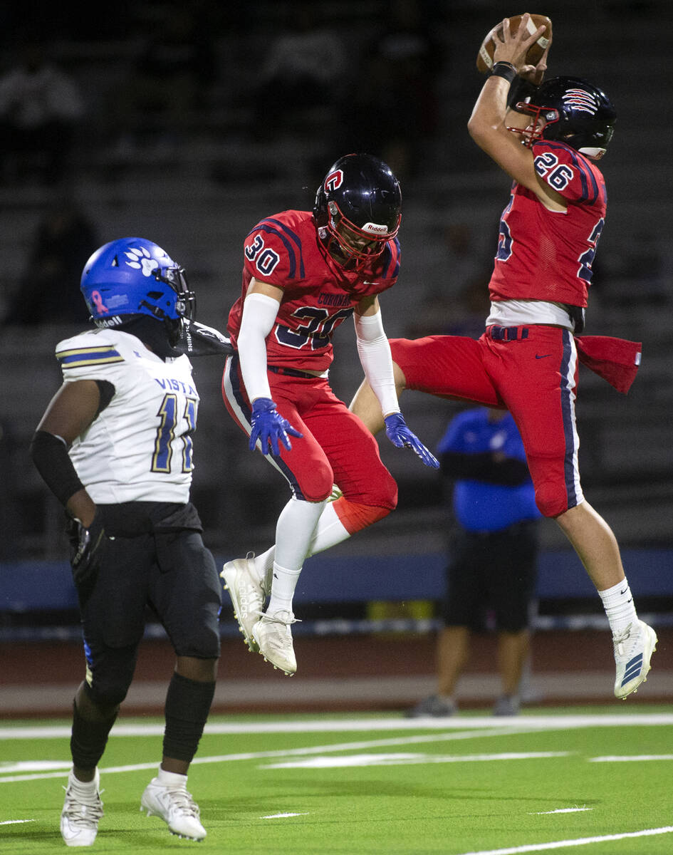 Coronado's Logan Cheney (26) catches an interception next to his teammate Jacob Heiny (30) as S ...