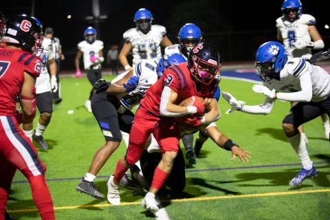 Coronado's Chris Avila carries the ball out of bounds as several Sierra Vista players close in ...