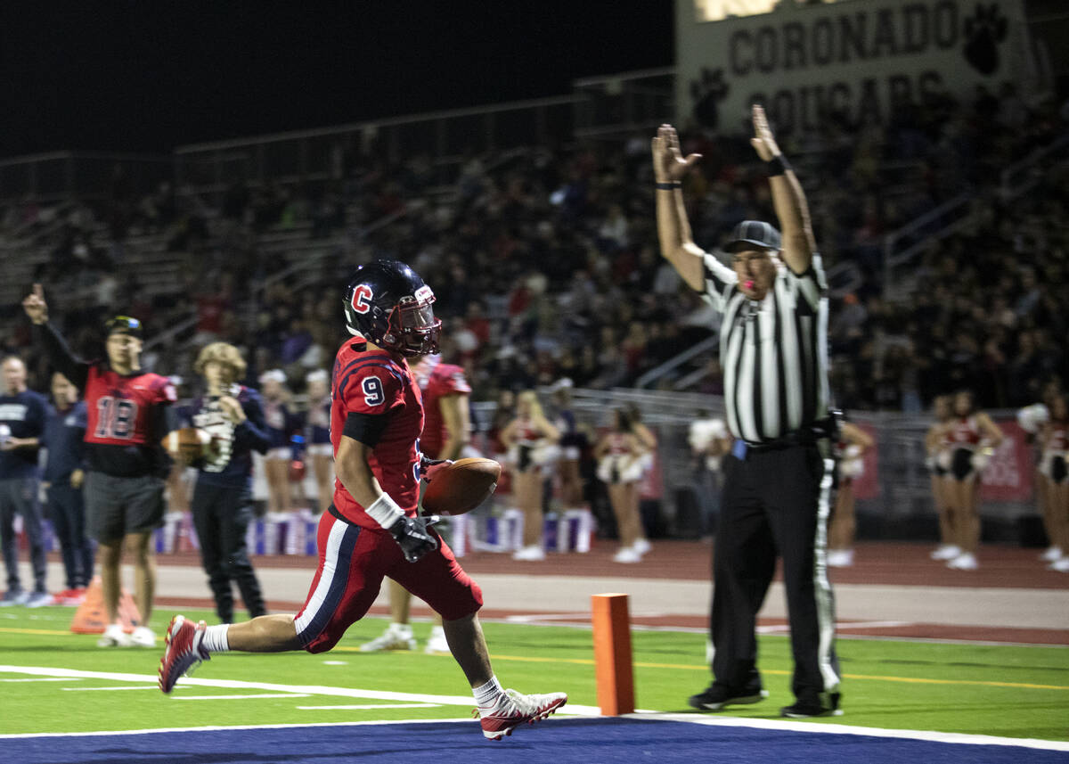 Coronado's Keona Espinoza (9) scores a touchdown during the first half of a high school footbal ...