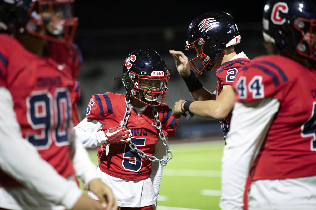 Coronado's Brandon Palmer (5) is congratulated by Logan Cheney (26) for catching an interceptio ...