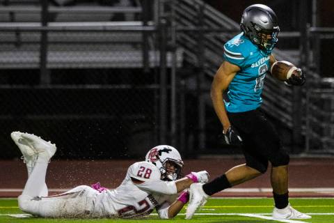 Desert Oasis defensive end Xzavery Simi (28) unable to stop Silverado High's running back Donav ...