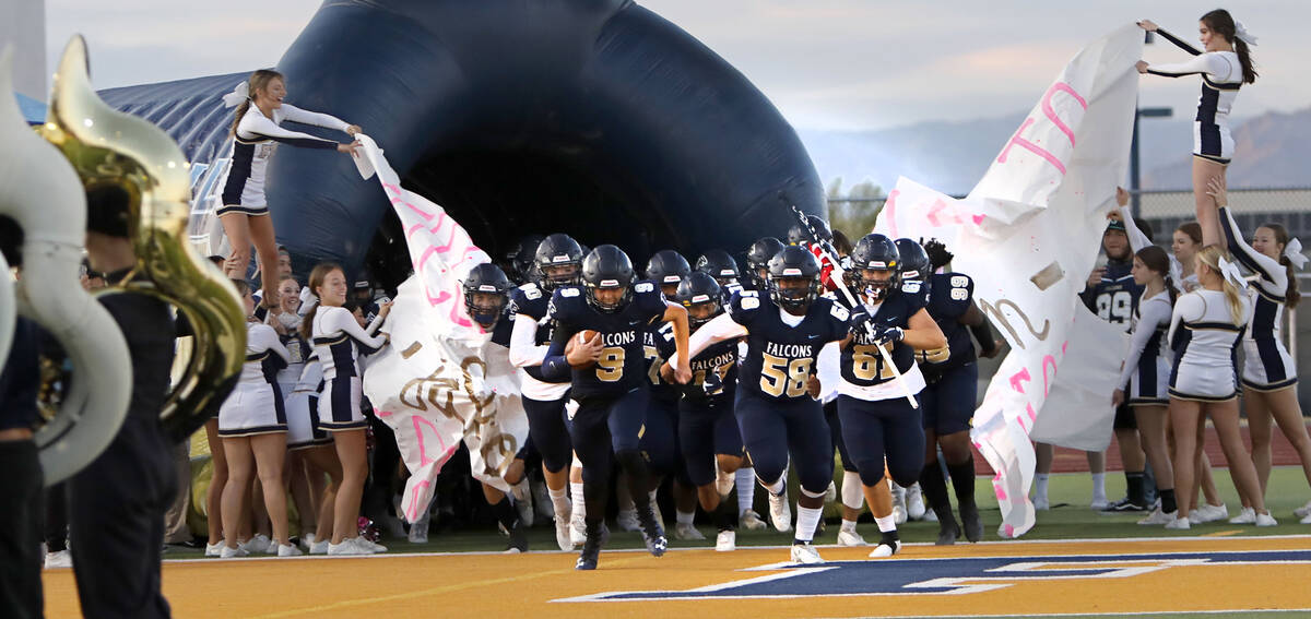 Foothill High School's players run out to the field before a football game against Bishop Gorma ...