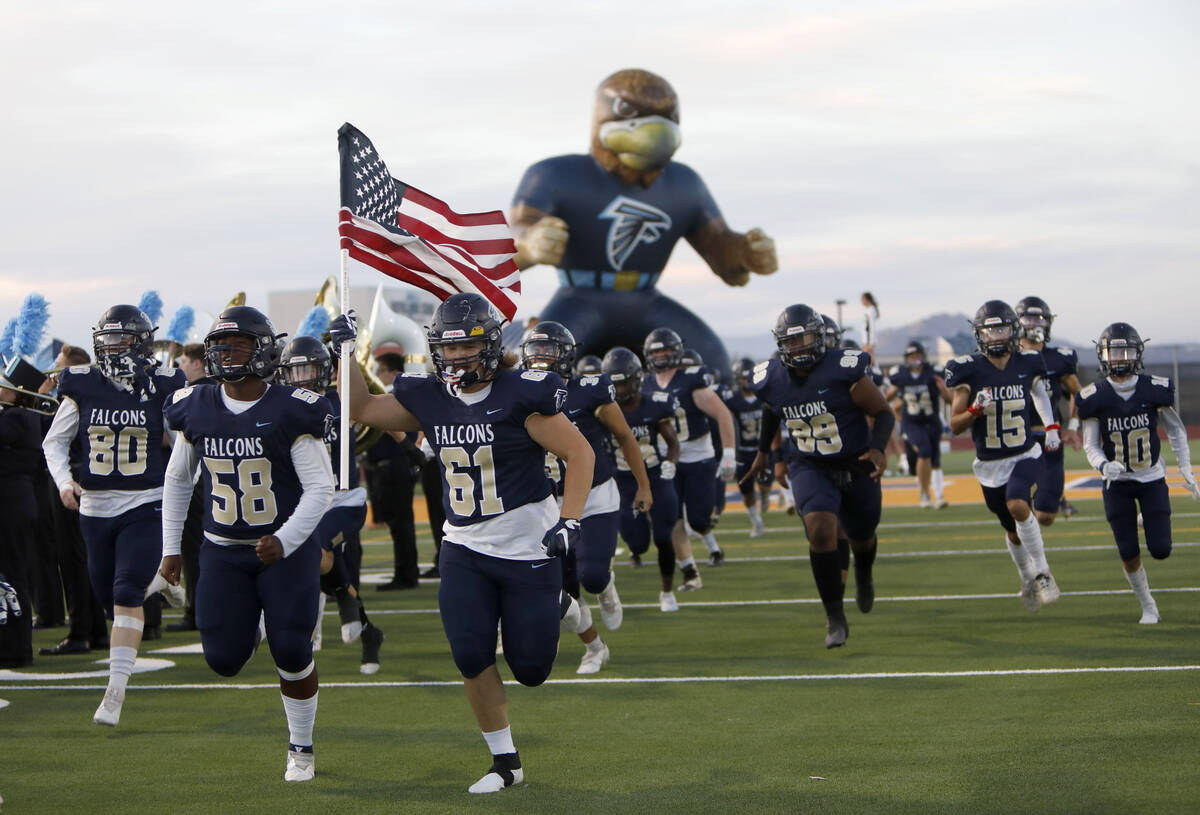 Foothill High School's players run out to the field before a football game against Bishop Gorma ...
