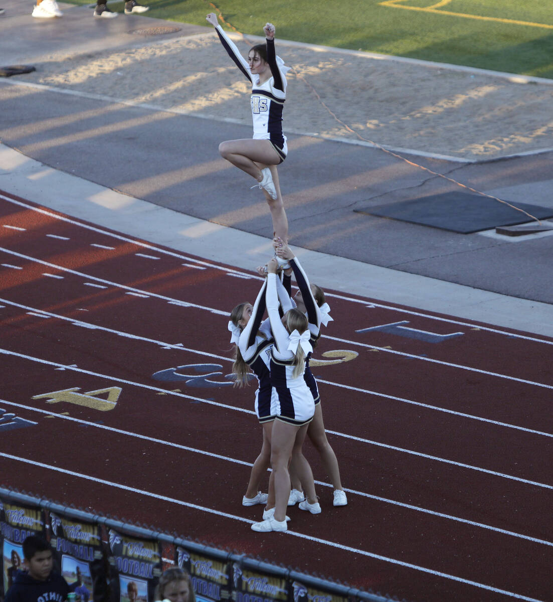 Foothill High School's cheerleaders performs before the first half of a football game at Foothi ...