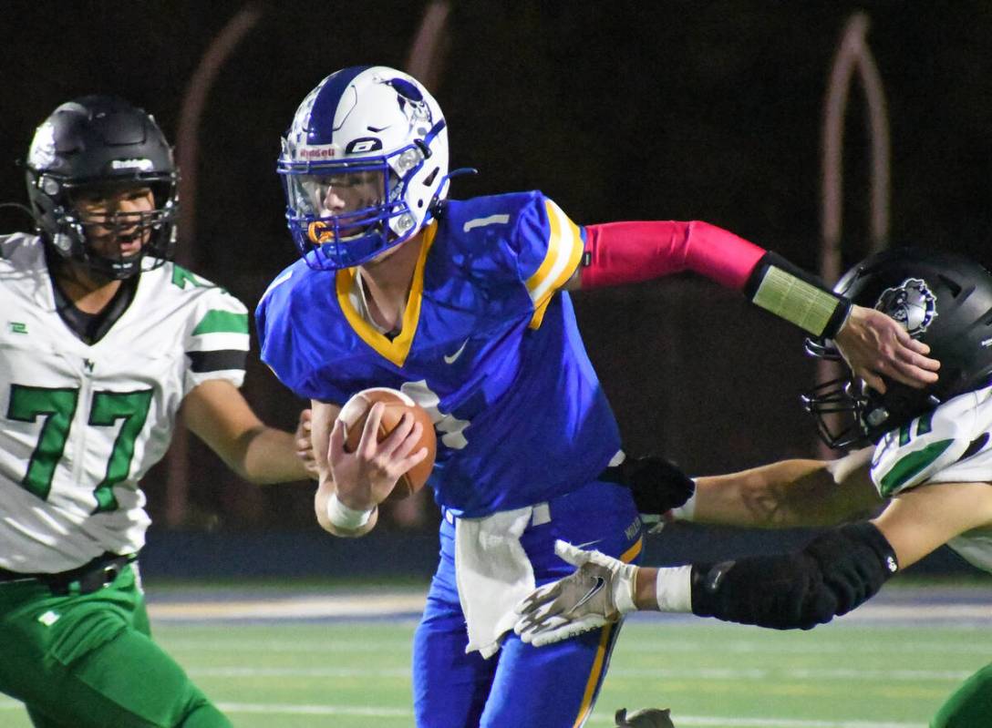 Moapa Valley quarterback Peyton Neilson avoids a sack during the Hammer Game against Virgin Val ...