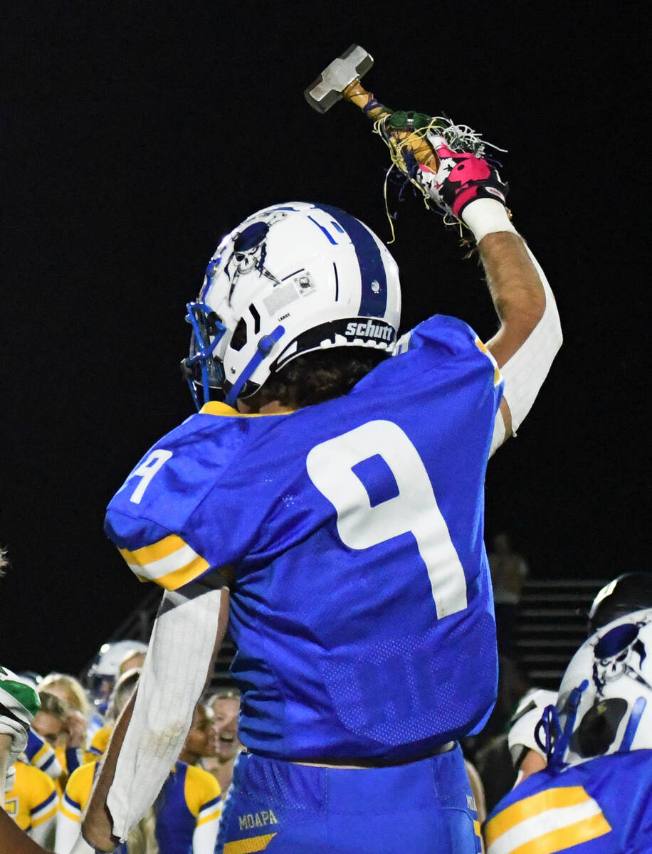 Moapa Valley’s Austin Heiselbetz raises the Hammer after a 46-28 victory over rival Virg ...