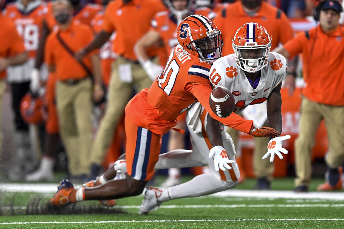 Syracuse defensive back Darian Chestnut, left, breaks up a pass intended for Clemson wide recei ...