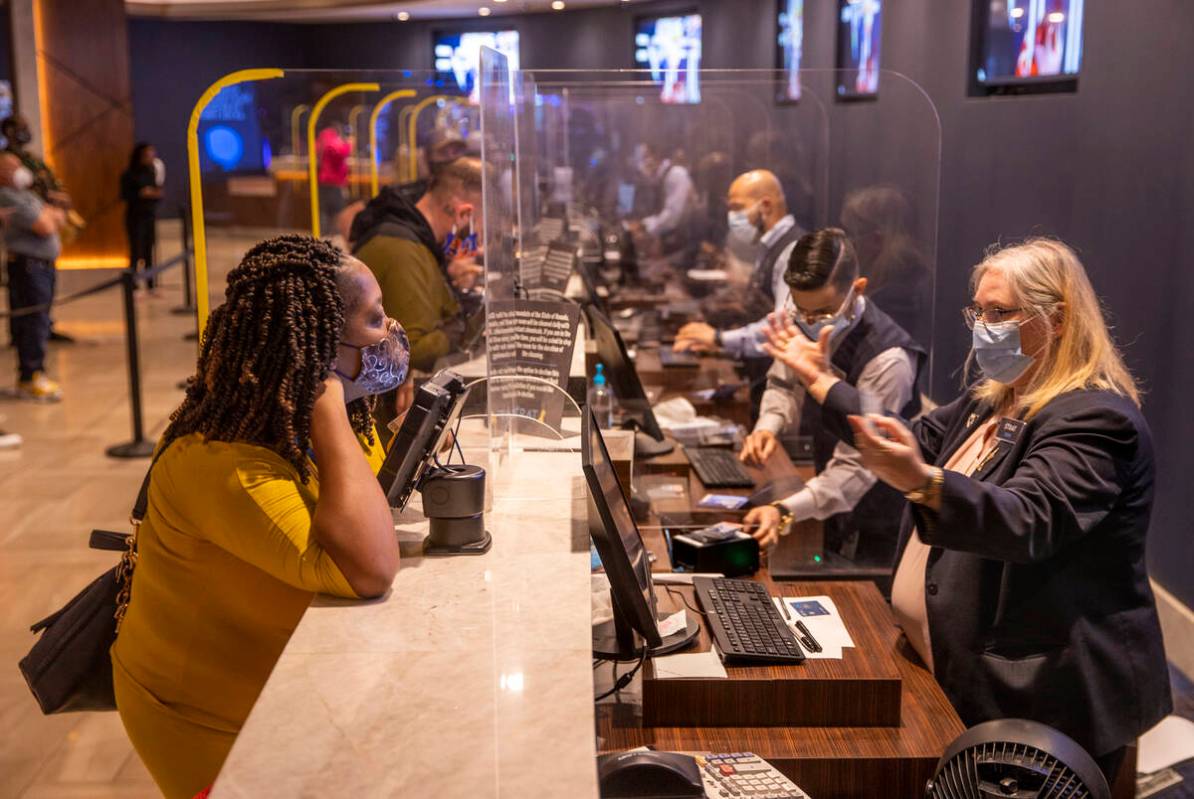 Kynetta Shinard, left, of Mississippi checks in at the front desk at The Strat as casino floors ...