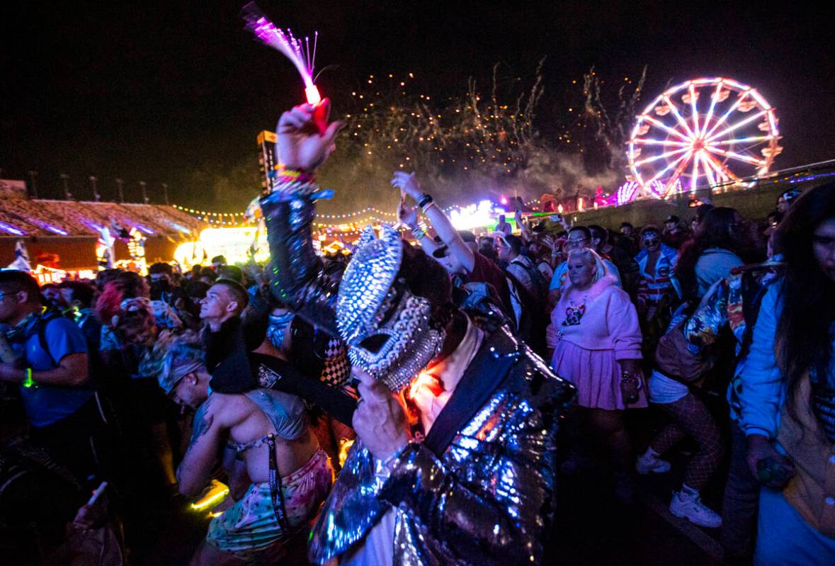 Attendees dance as Illenium performs a suprise set at the Forest House art car during the first ...