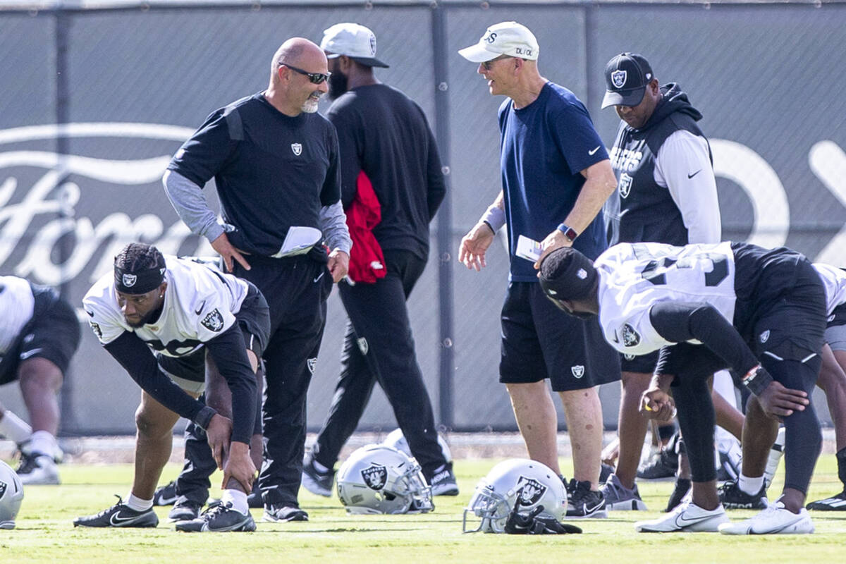 Raiders interim head coach Rich Bisaccia and defensive line coach Rod Marinelli interact during ...