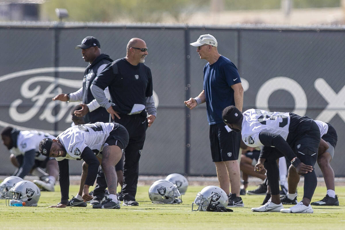 Raiders interim head coach Rich Bisaccia, left, and defensive line coach Rod Marinelli interact ...