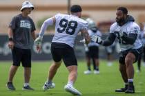 Raiders defensive line coach Rod Marinelli looks on as Raiders defensive ends Maxx Crosby (98) ...
