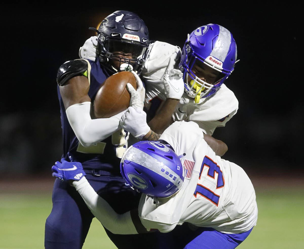 Foothill High School's Keshawn Wilridge Thomas (24), left, is tackled by Bishop Gorman High Sch ...