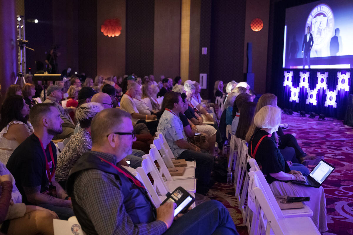 Audience members listen to speaker Jason Sullivan, a former aide to Roger Stone and former advi ...