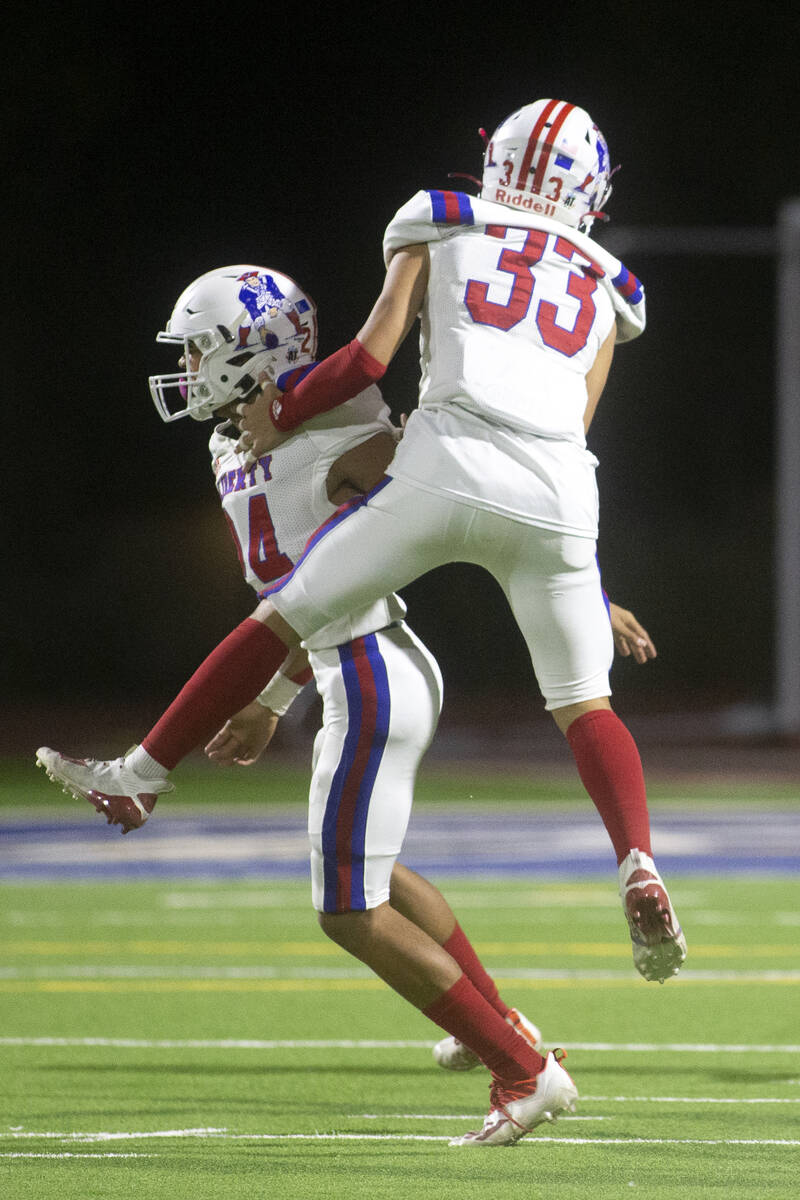 Liberty's Isaiah Hampton (24) and Ryden-james Dacosin (33) celebrate one of their team's touchd ...