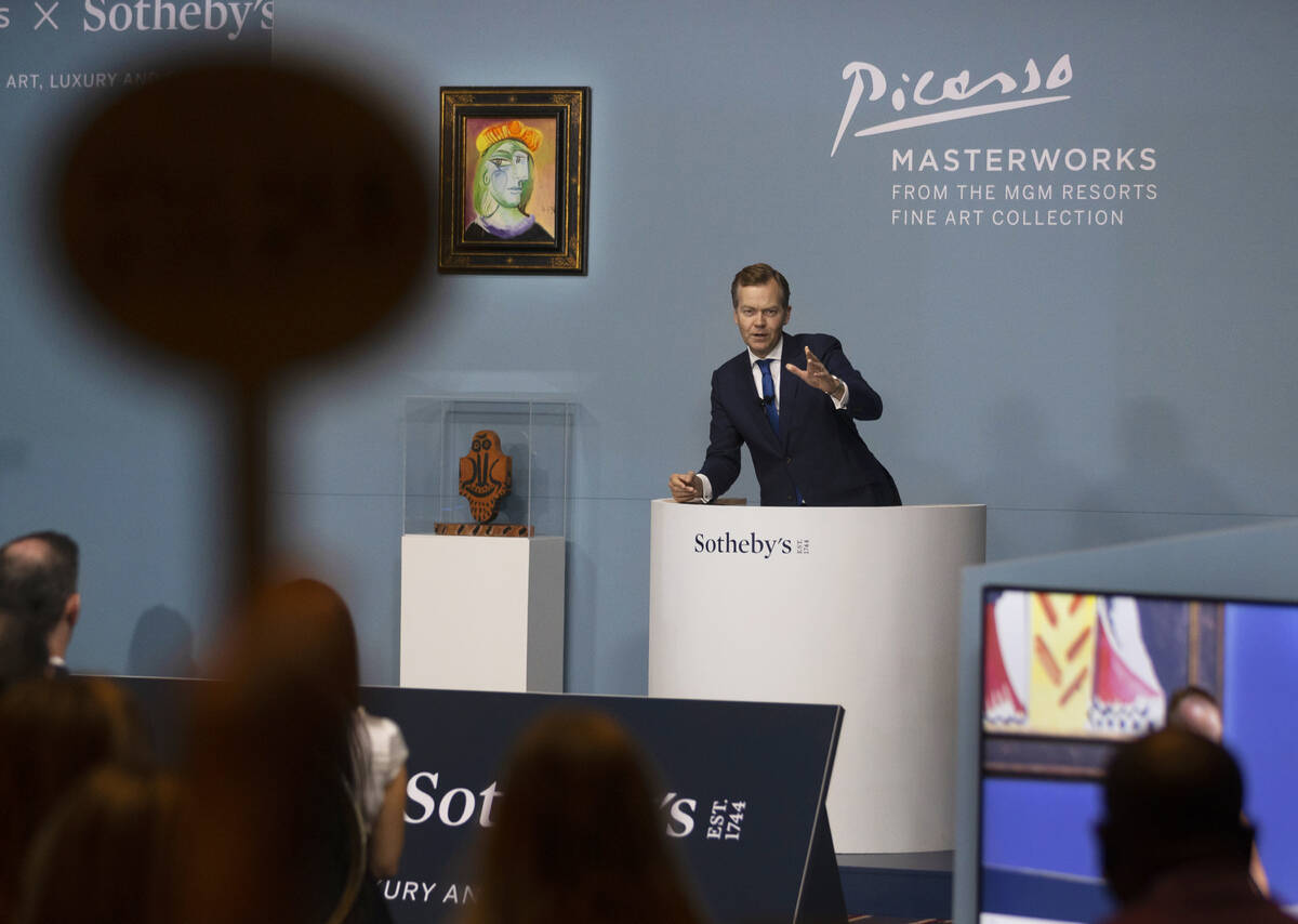 Oliver Barker, right, takes bids during an auction held by Sotheby's featuring eleven of Pablo ...