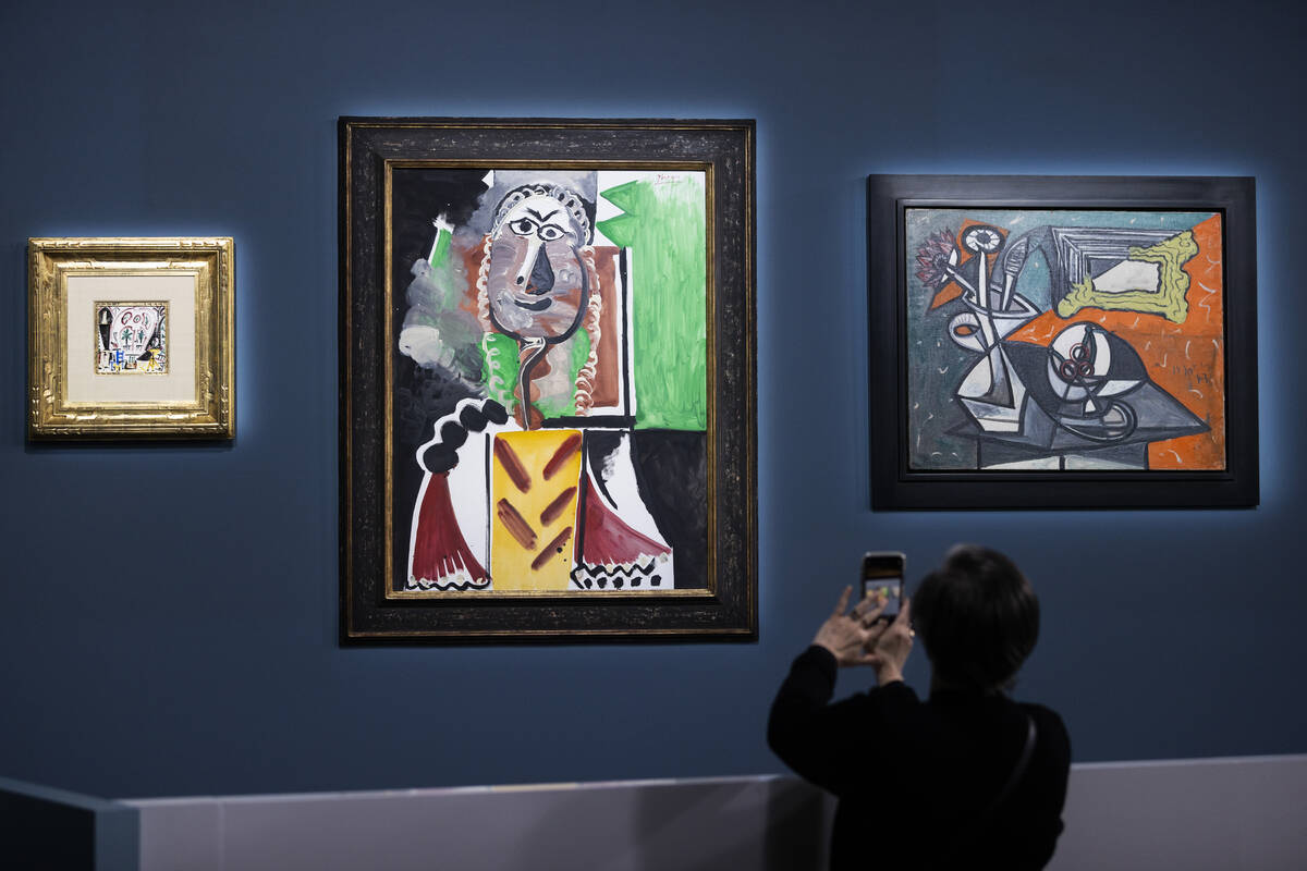 Guests take photos during an auction held by Sotheby's featuring eleven of Pablo Picasso&#x2019 ...
