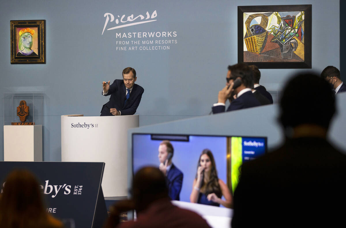 Oliver Barker, top/left, takes bids during an auction held by Sotheby's featuring eleven of Pab ...
