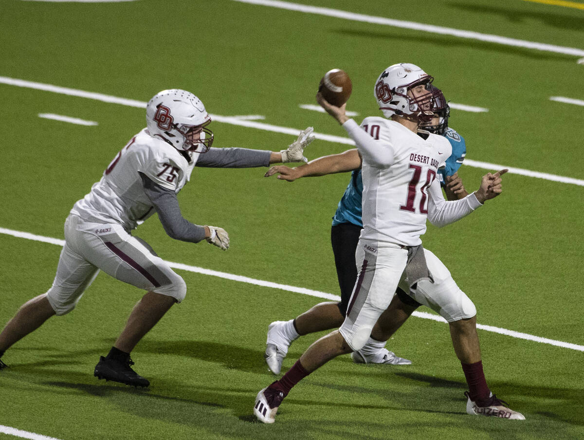 Desert Oasis quarterback Tyler Stott (10) throws under pressure against Silverado High during t ...