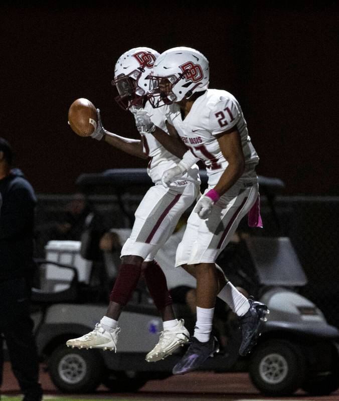 Desert Oasis wide receiver Elijah Darwin (8) celebrates his touchdown with wide receiver Maveri ...