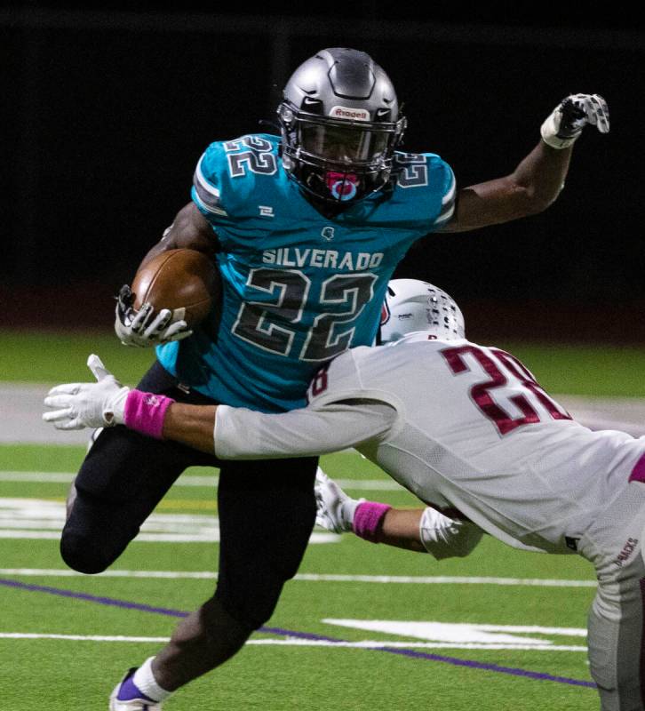 Silverado HighÕs running back Caden Harris (22) eludes Desert Oasis defensive end Xzavery ...