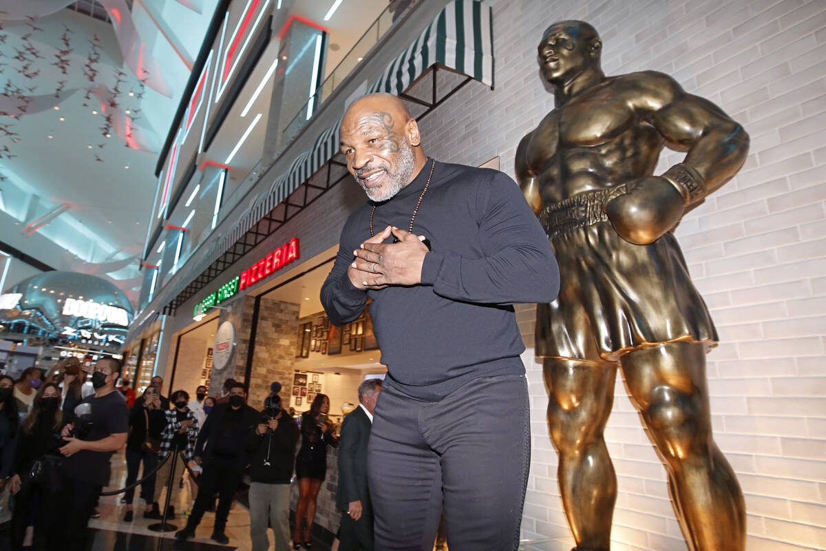 Former boxer Mike Tyson greets people in front of newly unveiled his stature at Mulberry Street ...